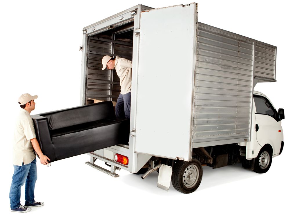 Delivery men loading a sofa in a truck - isolated over white.jpg