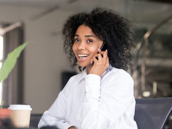  Image of a woman smiling while talking on the phone