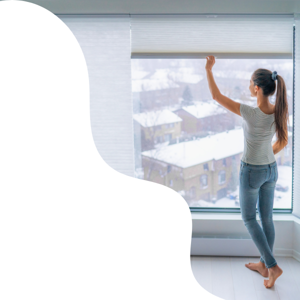 woman adjusting window shades