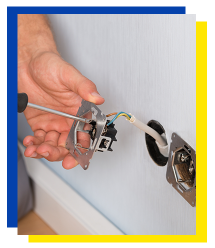 Electrician Installing a new electrical outlet in a Chicago, IL area home