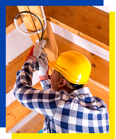 An electrician from Chicago installs new lighting in a garage