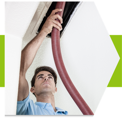 Man vacuuming a vent