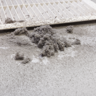 Large particles of dust falling off an air duct. 
