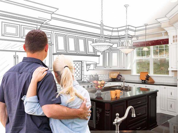 A couple holding each other as they imagine a new kitchen
