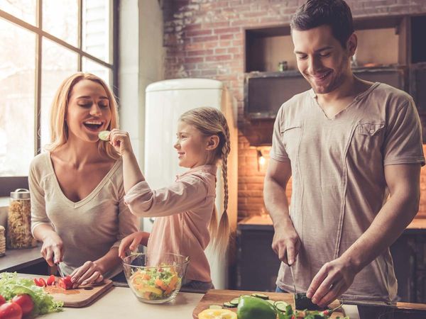 A happy family preparing a meal together