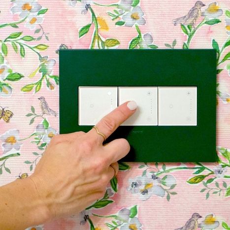 Image of a hand turning on a dimmer in a baby's room