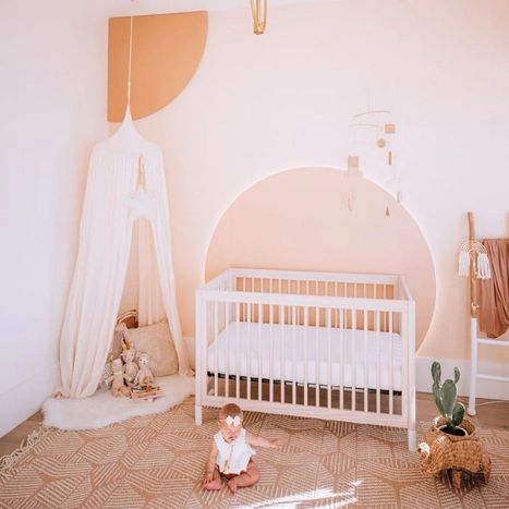 Image of a warm-toned nursery with a baby on the floor