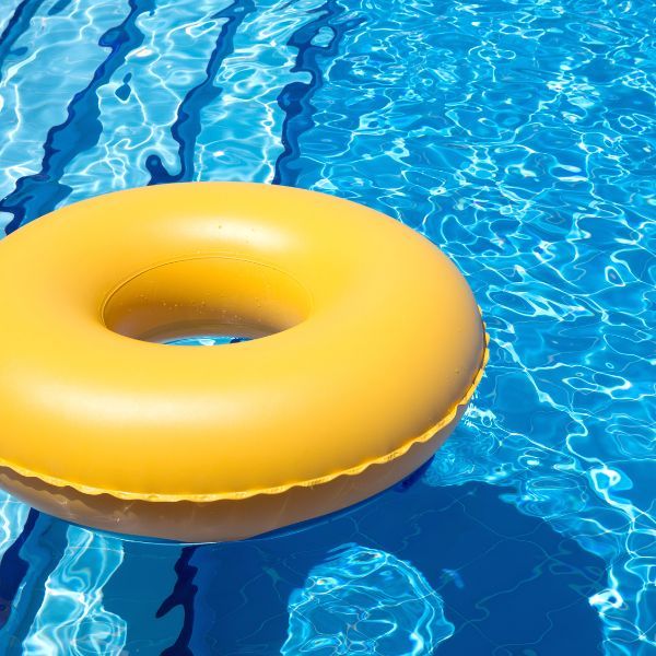 yellow floaty ring in bright blue pool