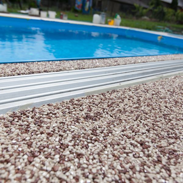 pebble aggregate deck around blue pool