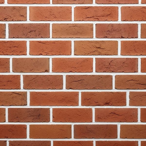 A detailed close-up of a red brick masonry wall, showing the clean, precise white mortar lines and rich texture of the bricks