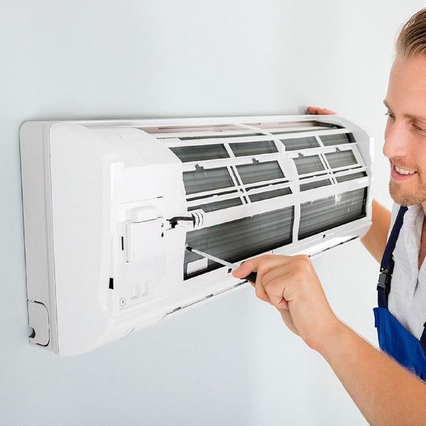 HVAC tech doing a repair HVAC tech doing a repair