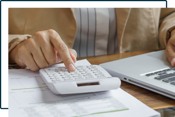 person using a computer and calculator