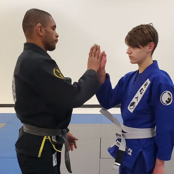 instructor and student practicing jiu-jitsu