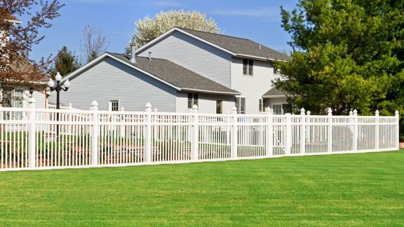 House surrounded by a white fence