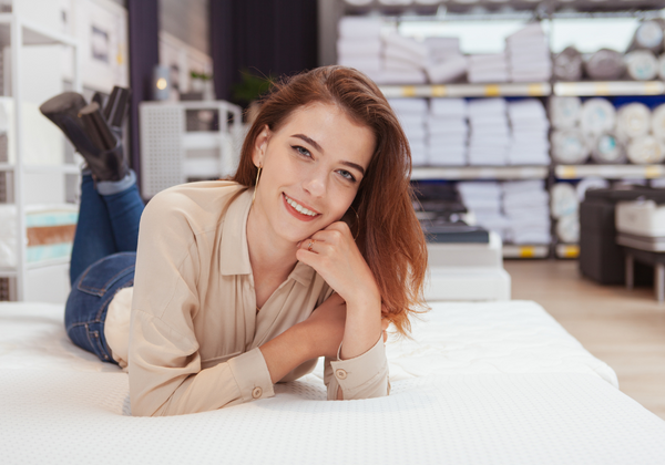 Young woman laying on a mattress