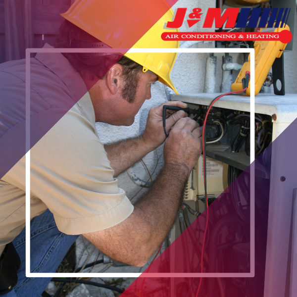 An HVAC technician running diagnostics