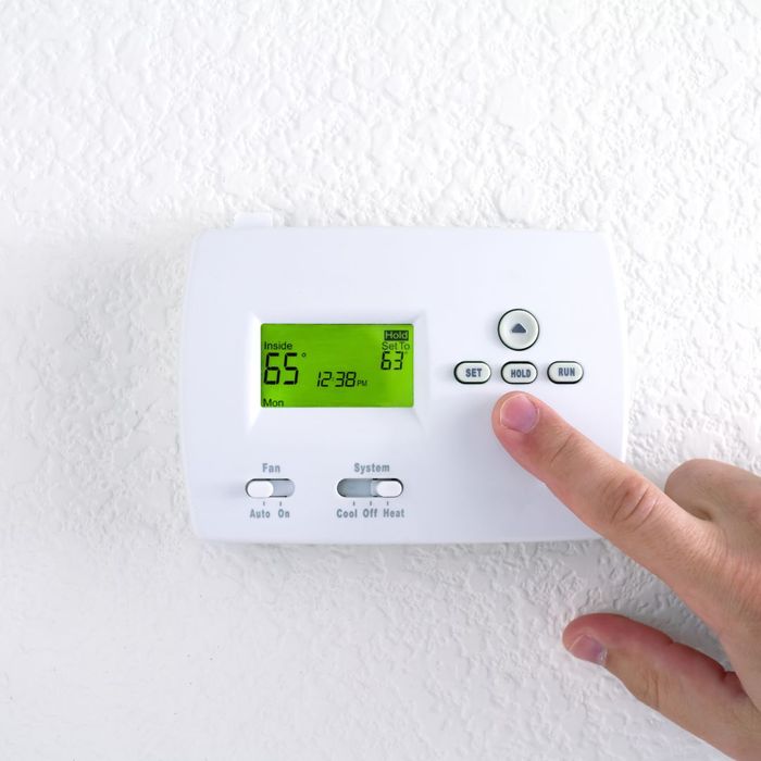 Person turning up thermostat