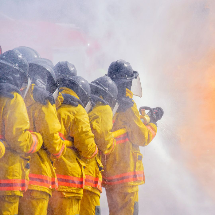 group of firefighters holding hose