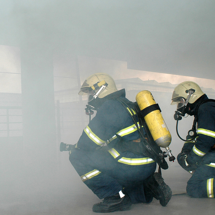 firefighters practicing inhalation techniques in smoke