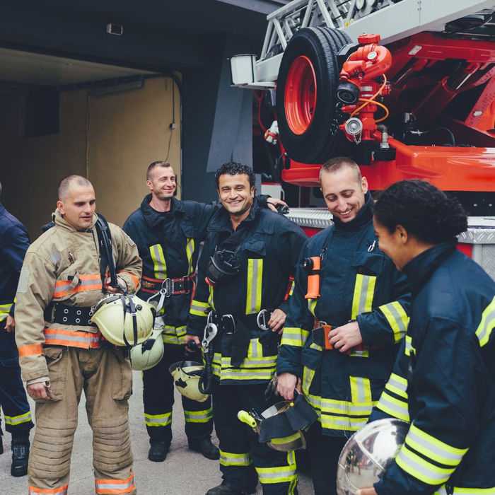 A group of firefighters in a group talking