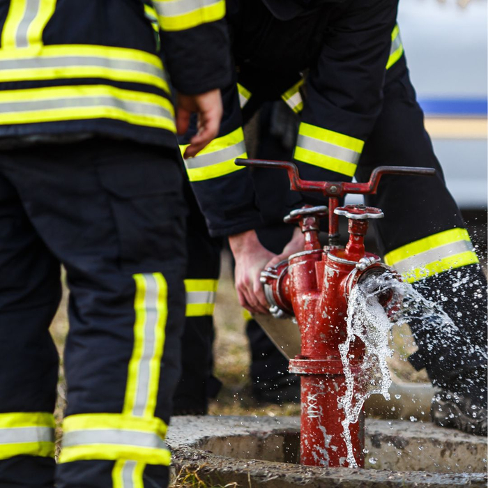 Firefighters training on hydrant and fire hose attachment