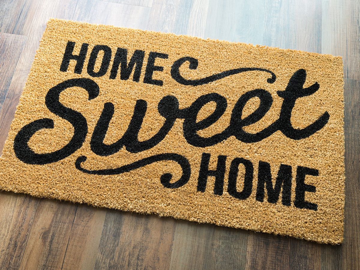 An image of a door mat with ‘Home Sweet Home’ printed on it.