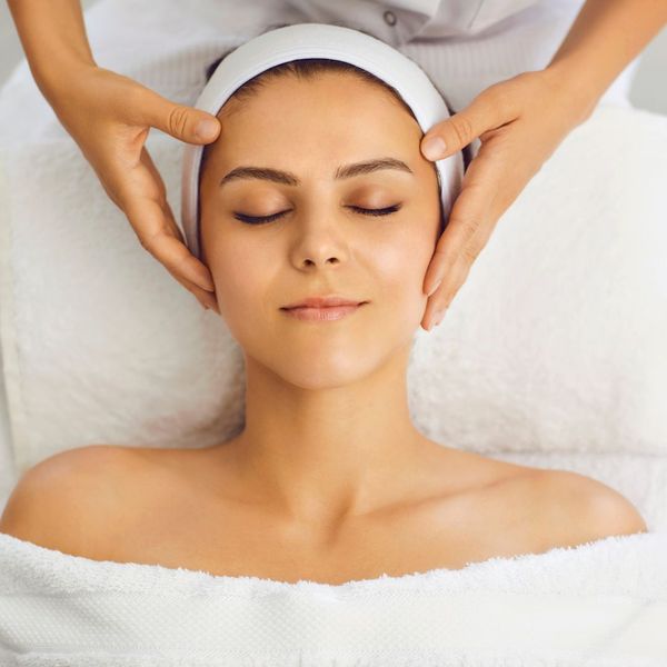 relaxed woman receiving a facial