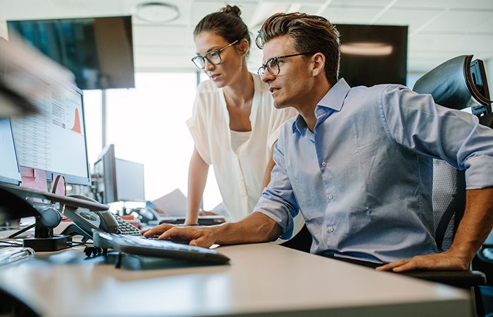 business people looking at work on a computer together