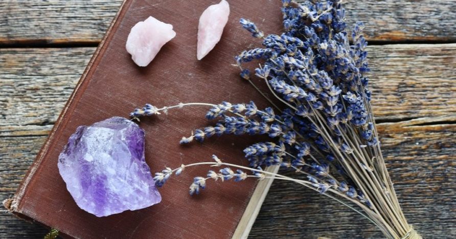 crystals and lavender on top of a book