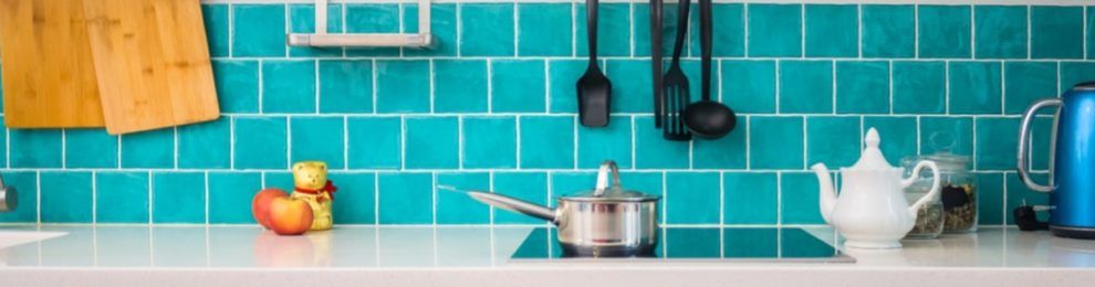 a white countertop in a teal kitchen