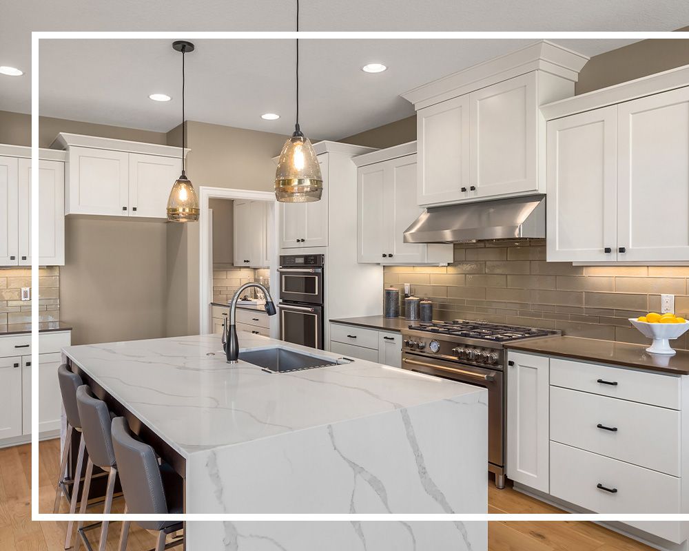 white and grey quartz countertops in a white and silver kitchen