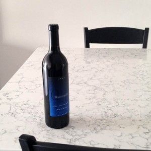a bottle of wine on a quartz countertop