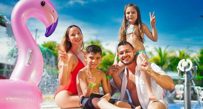 a family by a pool Carry On Essentials You Need for a Family Friendly Vacation Hero.jpg