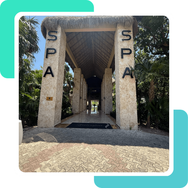 The beautiful stone entrance to a luxurious spa with a thatched roof at a tropical all-inclusive resort. The beautiful stone entrance to a luxurious spa with a thatched roof at a tropical all-inclusive resort.