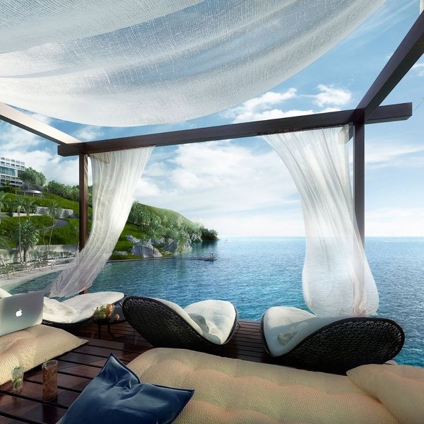 A cozy, canopied bed with sheer curtains overlooking a tranquil ocean, suggesting a romantic, tropical getaway. A cozy, canopied bed with sheer curtains overlooking a tranquil ocean, suggesting a romantic, tropical getaway.