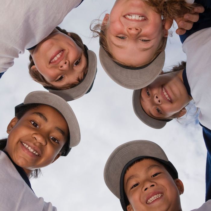 5 kids smiling looking down on the camera