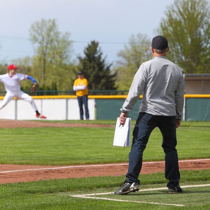 Baseball coach watches pitcher Baseball coach watches pitcher
