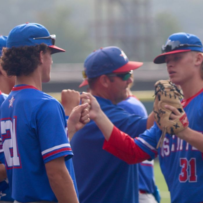 Baseball teammates fist bumping