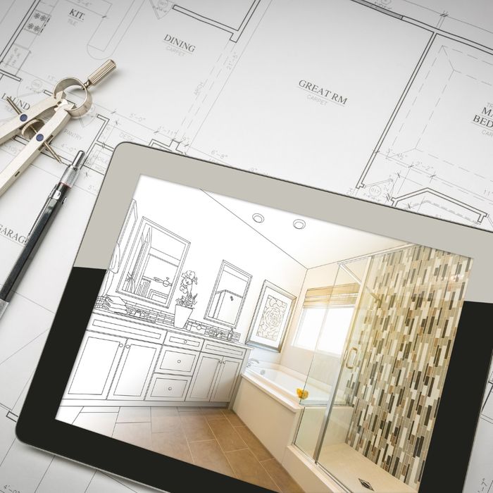 Blueprint and a tablet with a picture of a bathroom