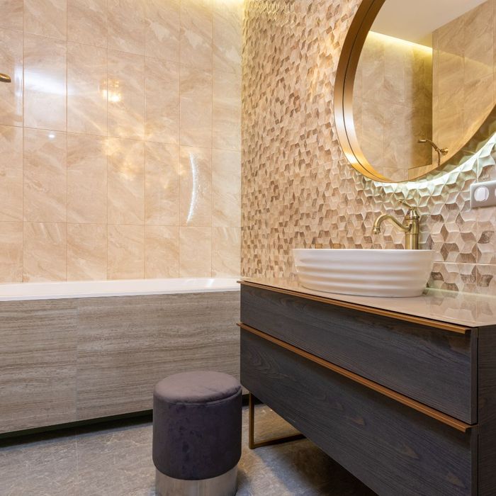 bathroom with textured tiled accent wall