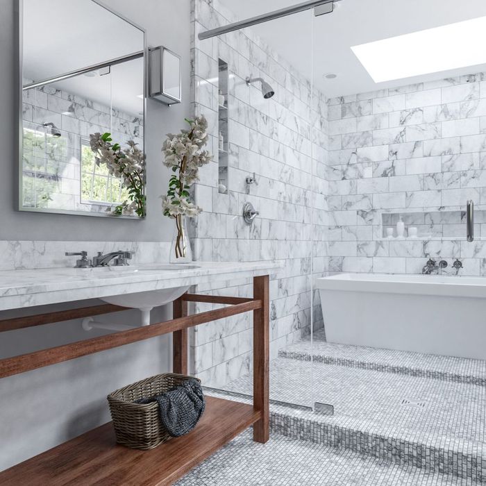 White tiled remodeled bathroom with tub and shower