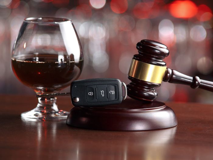 photo of beer sitting next to car keys and law gavel 