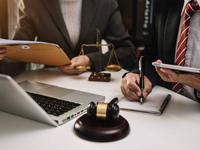 Lawyer businessman and two business partners working together in office. 