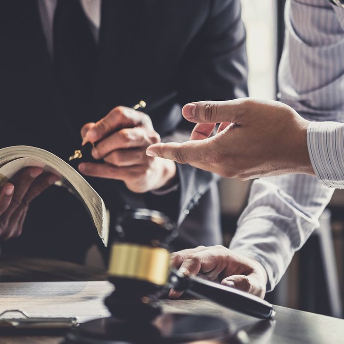 lawyers working with a book and gavel 