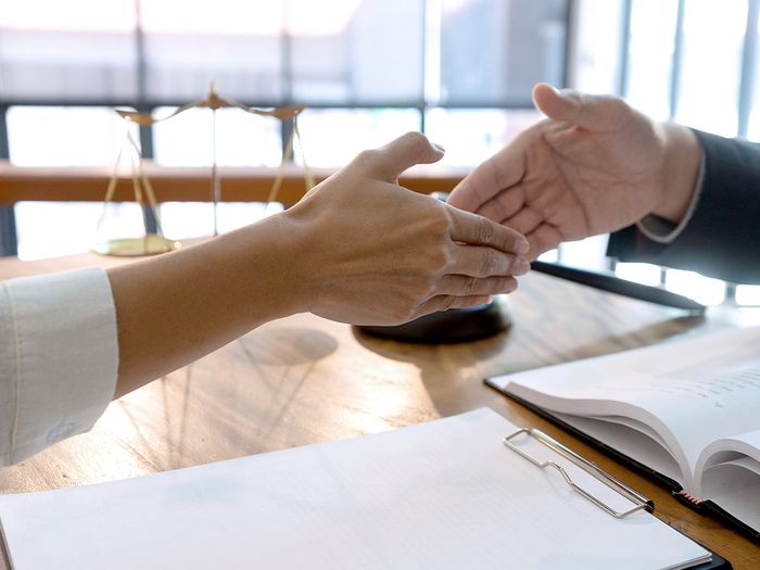  Lawyer or judge with gavel and balance handshake with client or customer