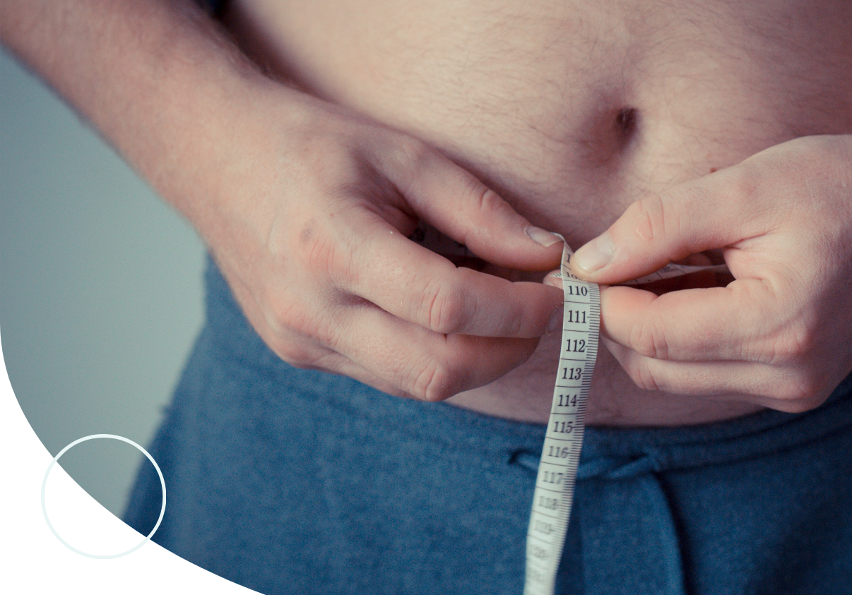 man measuring stomach
