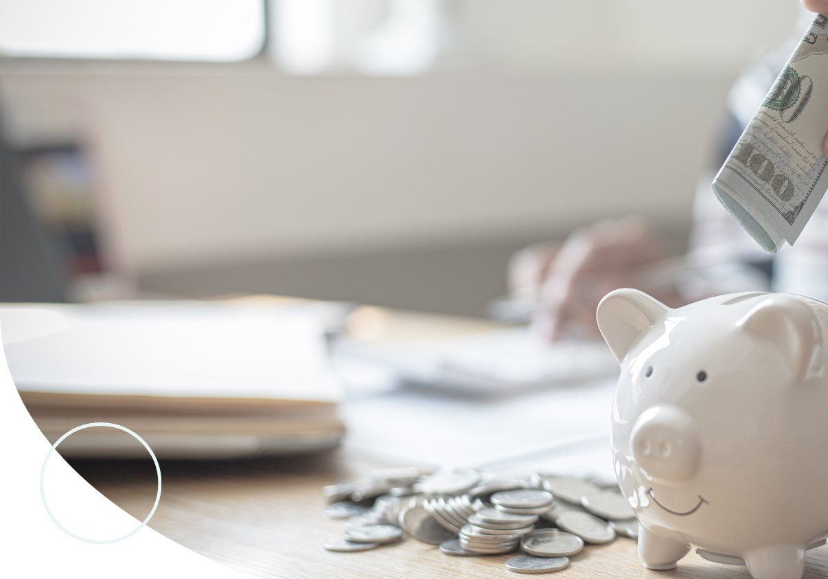 person putting money into piggy bank