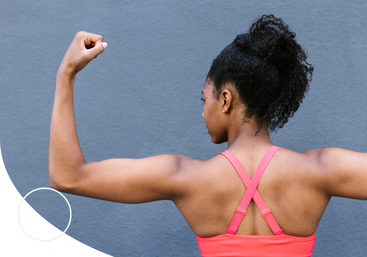 woman flexing arm and back muscles 