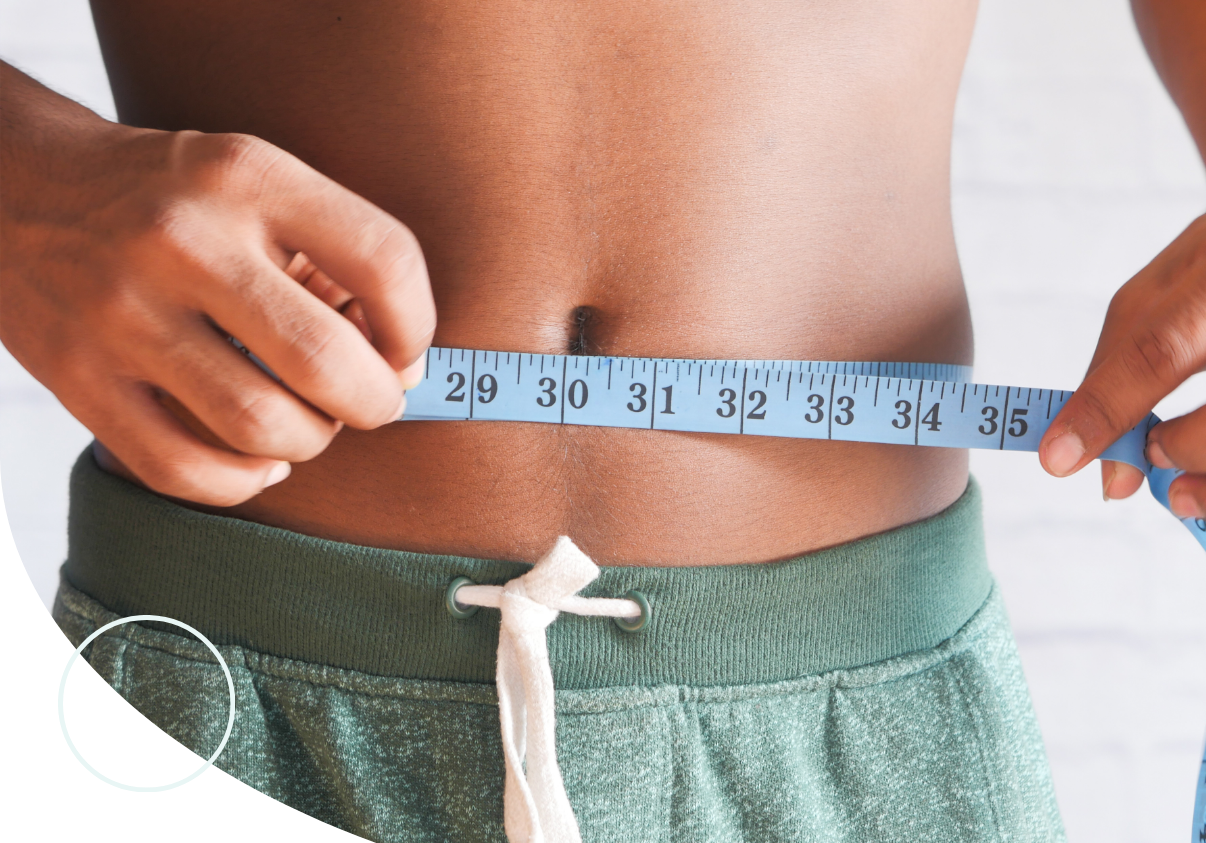 man measuring his waist during weight loss journey