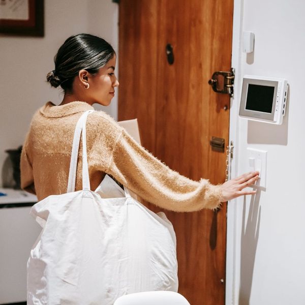 woman setting thermostat